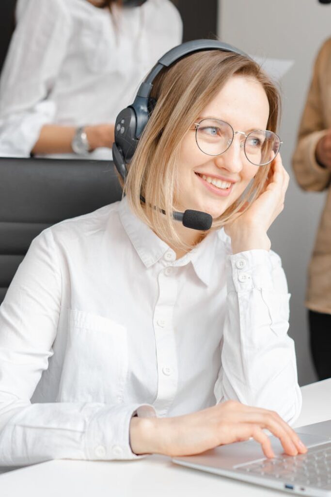 pexels-photo-7682211 Professional woman in headset offering customer support at a call center.